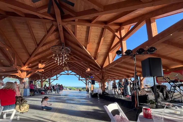 Guests under the timber roof of the pavilion as the band plays