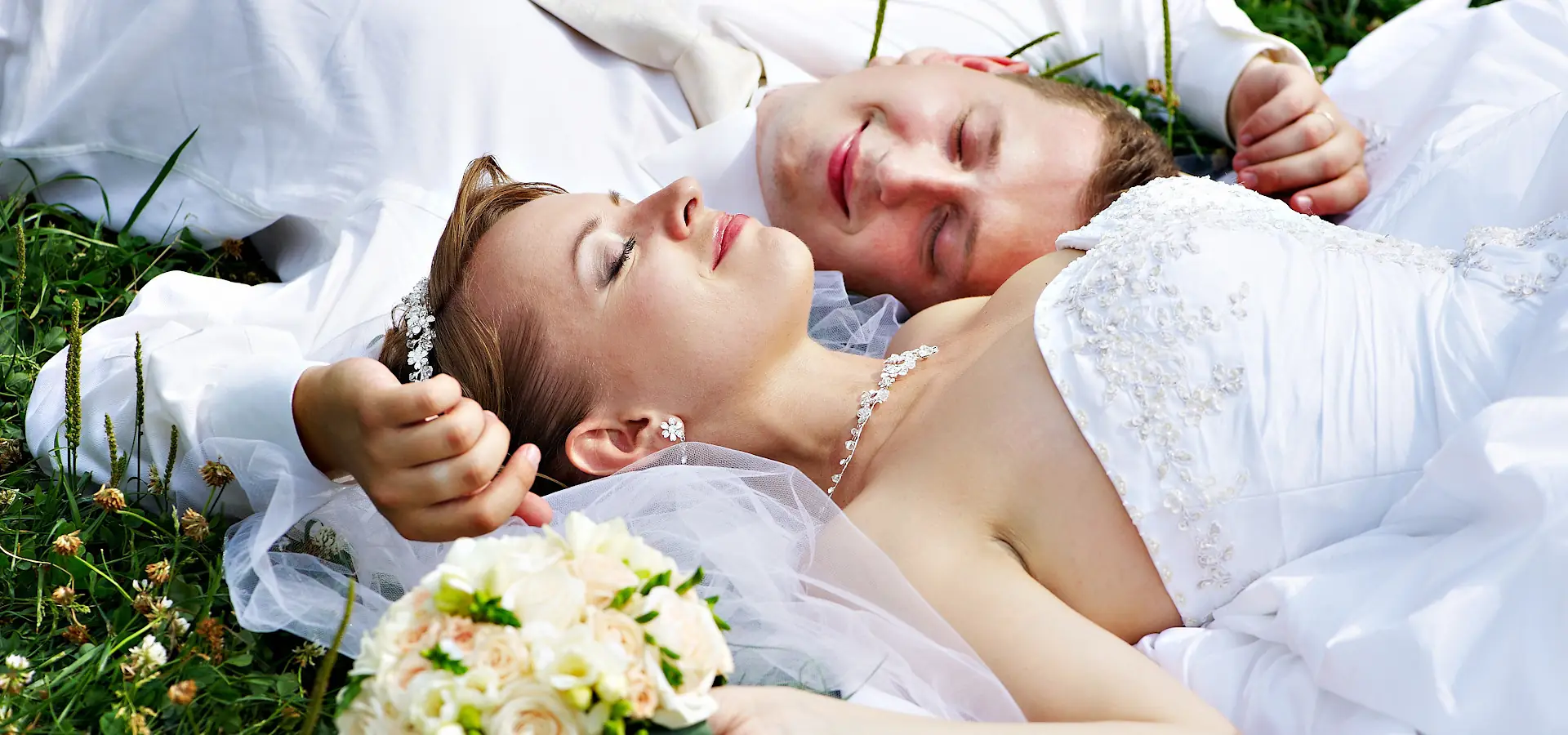 Wedding couple lying on the grass